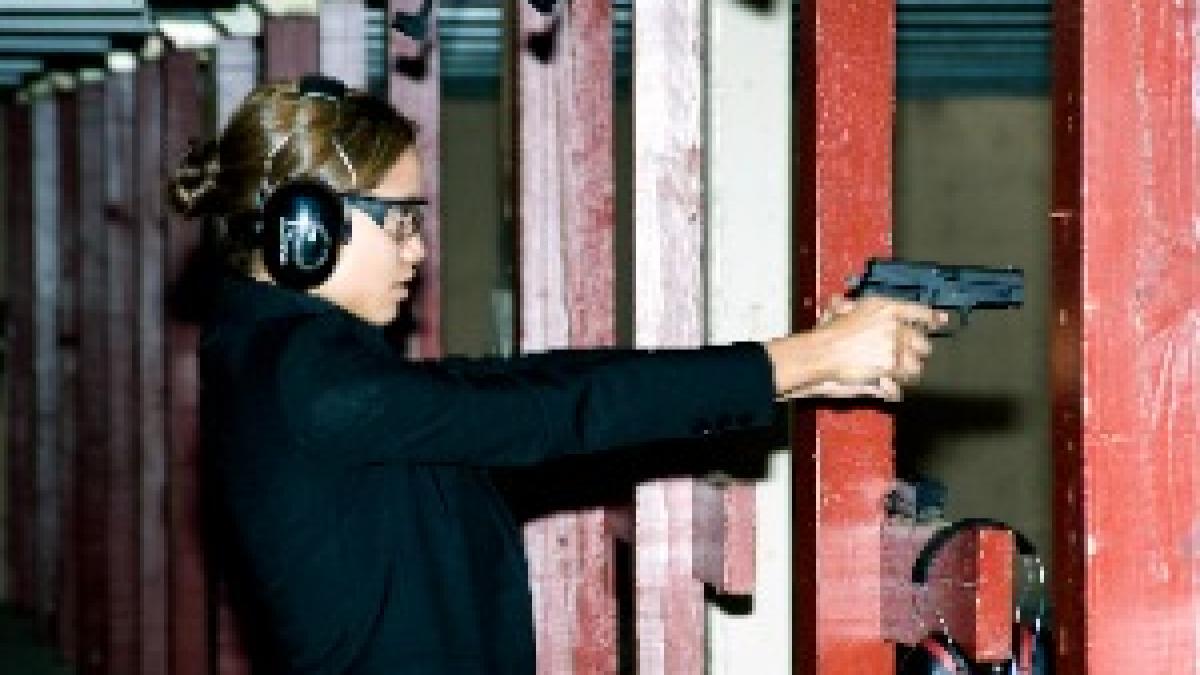 Rosario Dawson firing a M11 pistol
