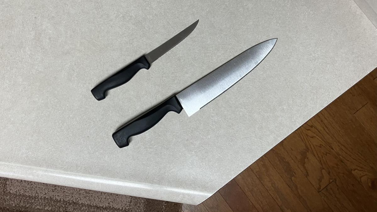 One big knife beside a smaller knife One big knife beside a smaller knife