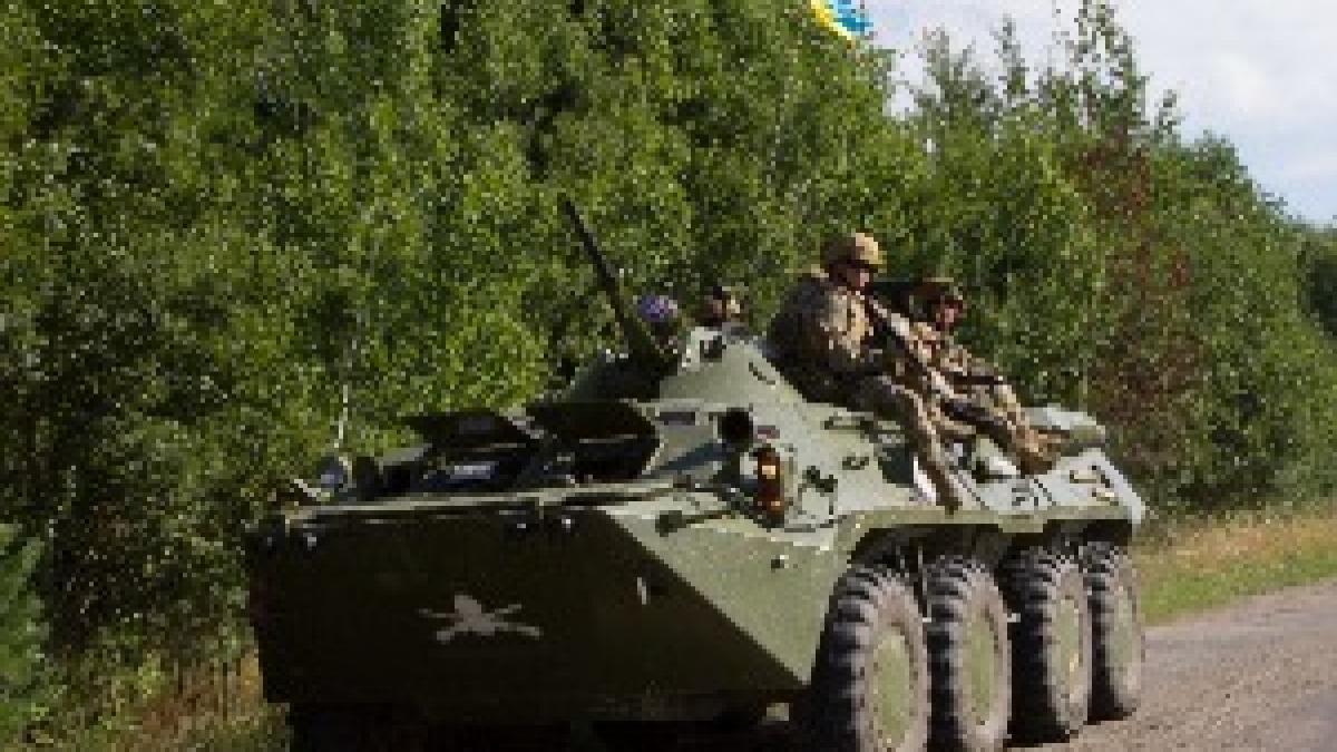 Soldiers with the Armed Forces of Ukraine ride their BTR-80