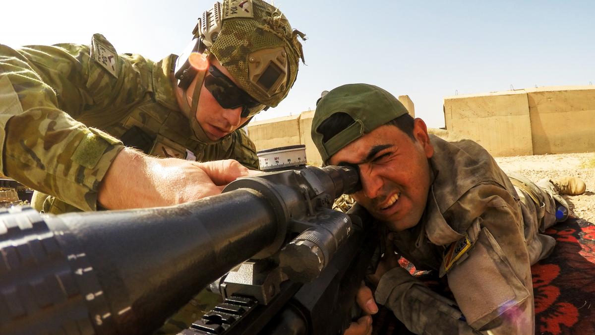 An Australian soldier attached to Task Group Taji adjusts an Iraqi soldier’s sniper scope in June 2016 An Australian soldier attached to Task Group Taji adjusts an Iraqi soldier’s sniper scope in June 2016