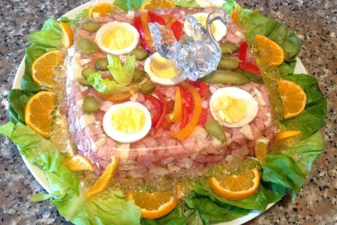 Холодец из свиных ножек варится на слабом огне для прозрачного бульона — повар