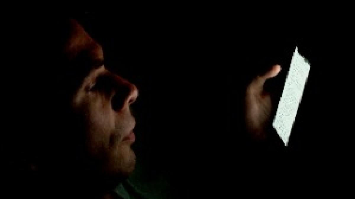 Person looking at smartphone in the dark (2)