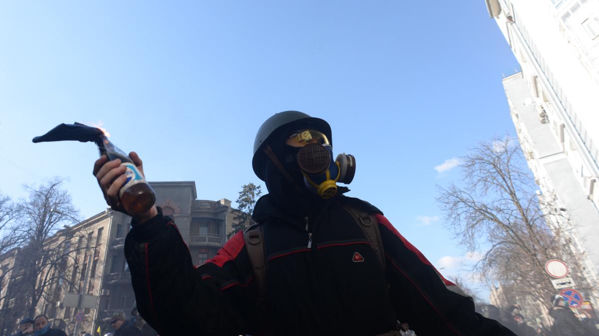 Masked protester holding Molotov Cocktails seen during clashes in Ukraine, Kyiv. Events of February 18, 2014 Masked protester holding Molotov Cocktails seen during clashes in Ukraine, Kyiv. Events of February 18, 2014