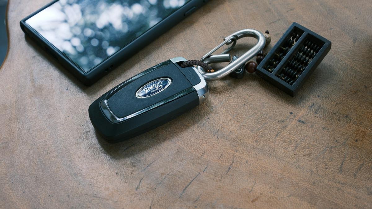 Современный ключ-брелок автомобиля, лежащий на деревянном столе