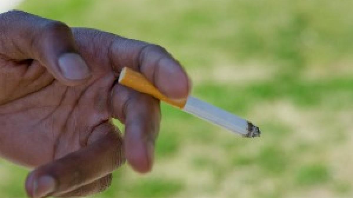 Holding lit cigarette