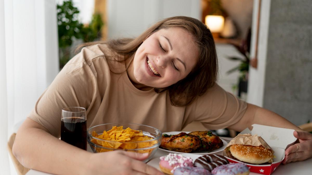Девушка ест фаст фуд и пьет куолу